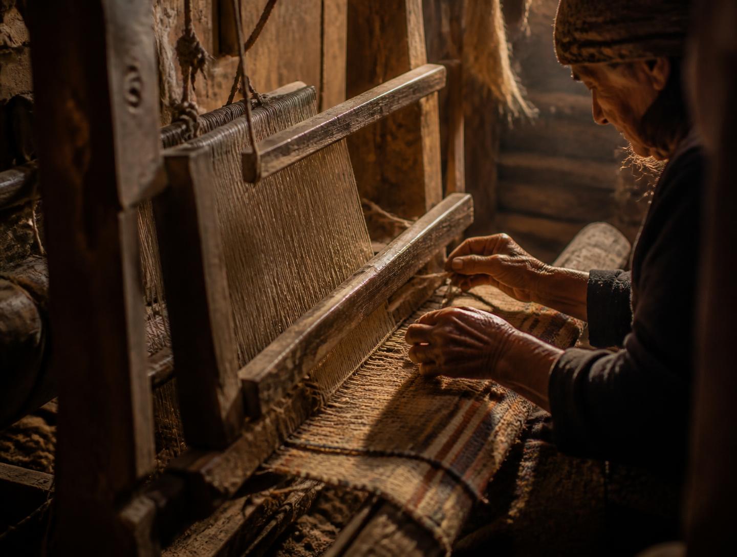 Artisan hand-weaving wool on a traditional loom