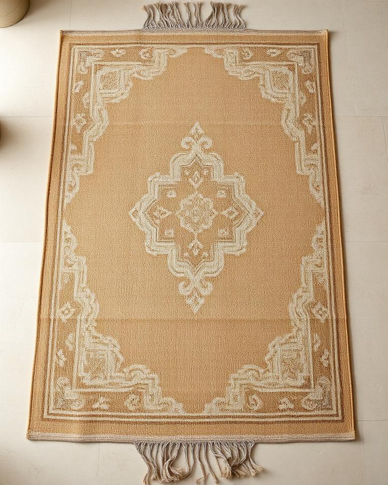 Terqa Medallion Rug — handwoven wool rug in warm caramel with an ivory medallion and border, 140×200 cm, styled in a minimalist cream interior